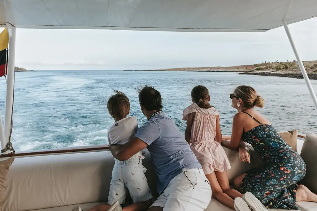 A family on the yacht deck looking out to sea