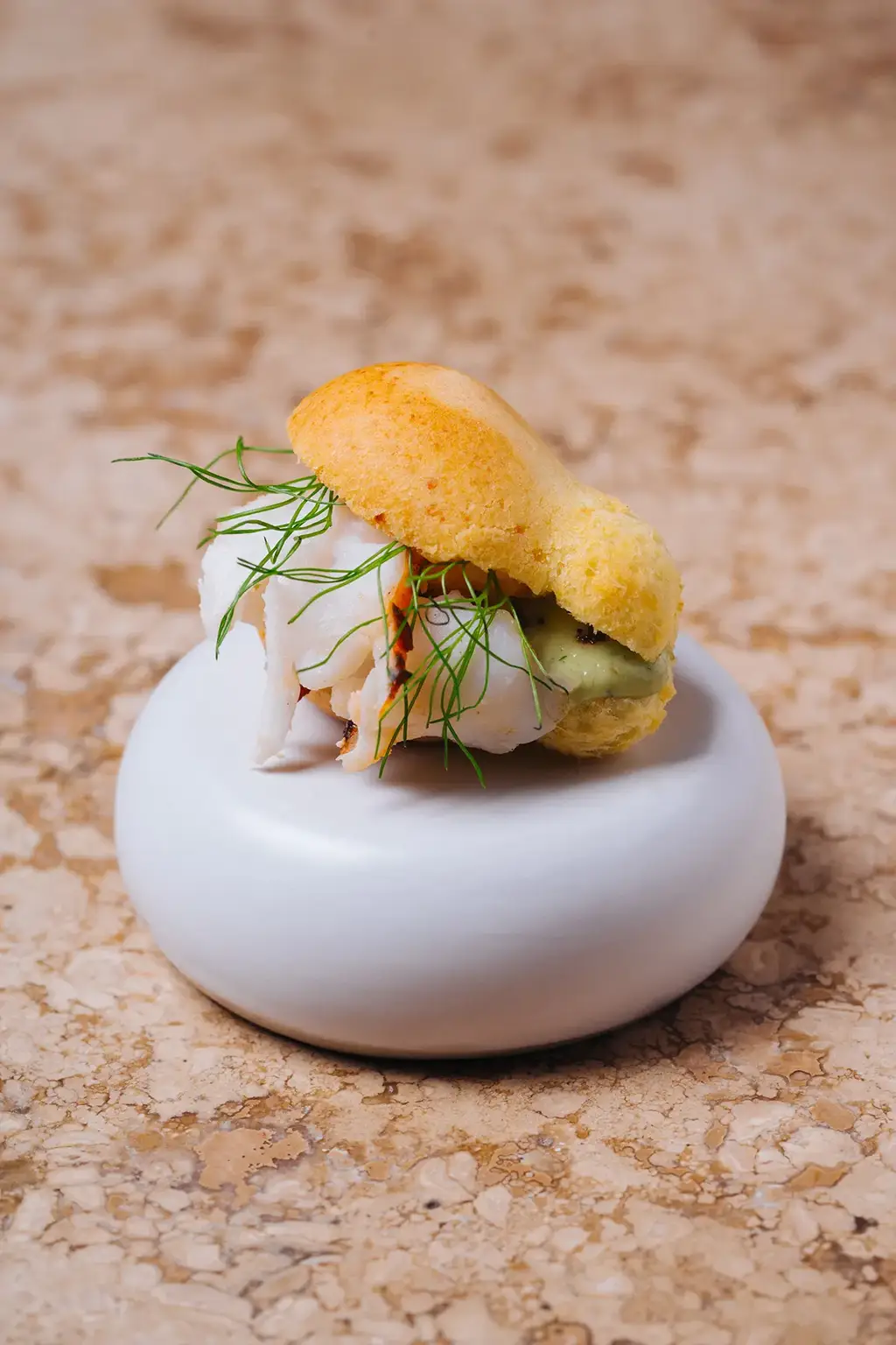 Gourmet slider on a ceramic pedestal