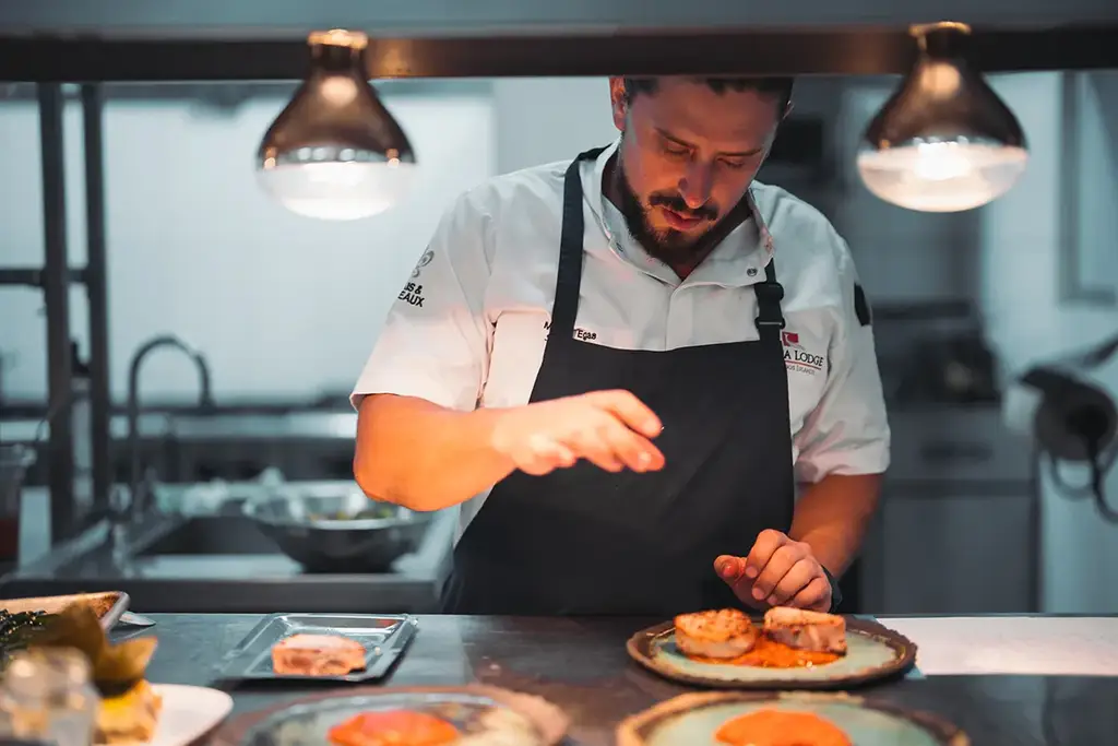 Chef plating a dish in the kitchen