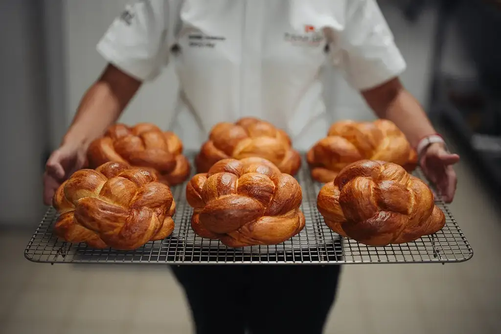Chef with fresh bread at Evolution by Pikaia