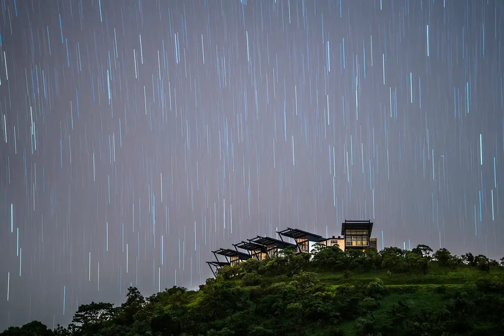 Pikaia Lodge under a star-trail sky in the Galápagos