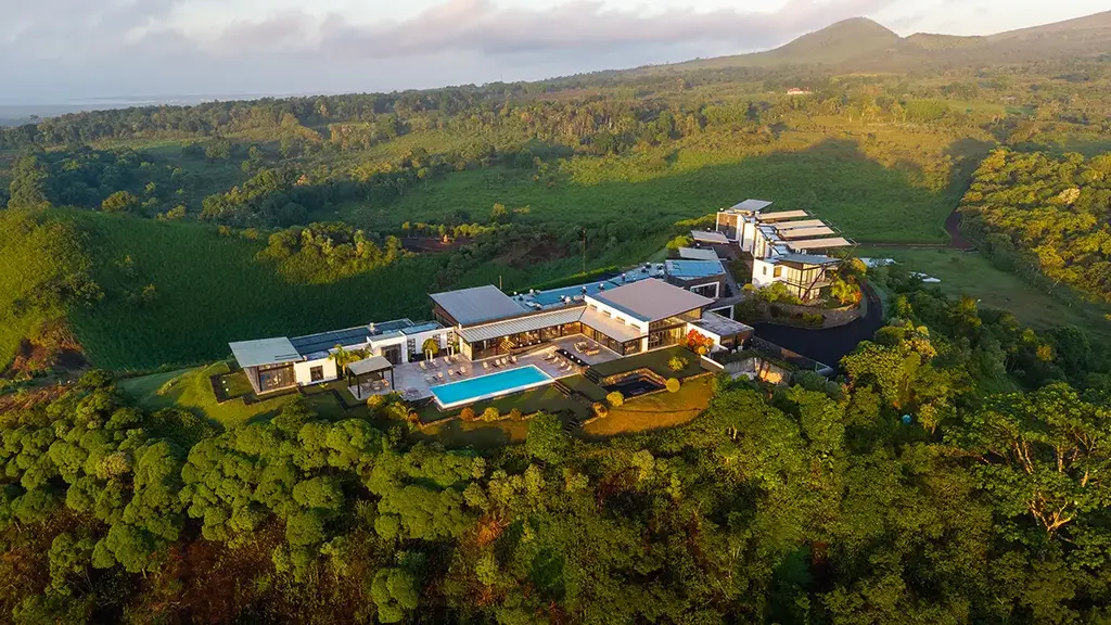 Aerial view of Pikaia Lodge and the infinity pool on the crater rim